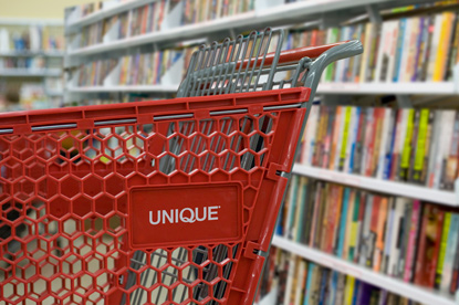 Unique shopping cart in book aisle.