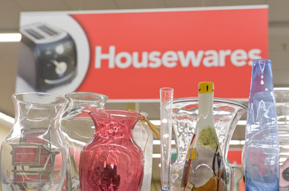 Glass vases on a shelf in the housewares department.