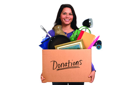 Person carrying a box of donated items.